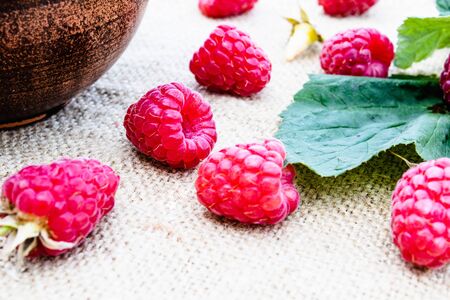 Ripe red raspberry lies on the background of old boards. Selective focus. Close-up.の写真素材