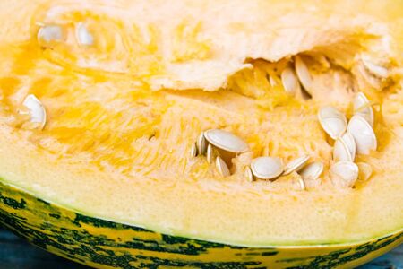 Closeup of a pumpkin with seeds on dark blue old boards. Autumn harvest.の写真素材
