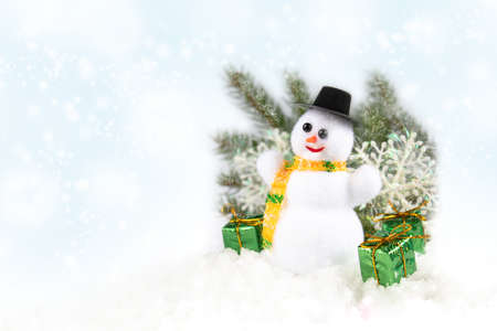 Christmas composition on a white background with a snowman, green spruce branches and gifts with copy space. New Year's Holidays.の写真素材