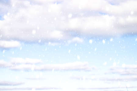 Winter landscape with falling snow on the background of blue clouds. Winter skyの写真素材