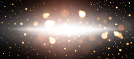Golden abstract bokeh background. Defocused abstract flickering lights on a black background. Golden bokeh.の写真素材