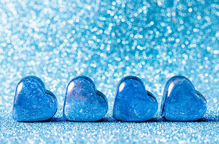 Glass blue hearts on a blue background. Concepts of valentines day card, wedding and invitation. Place for your text.の写真素材
