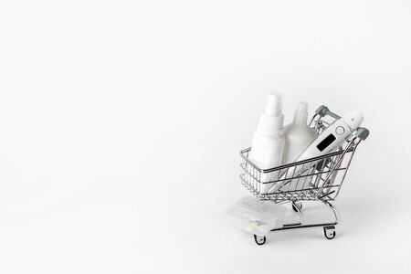 thermometer, gel and spray for disinfection in a shopping cart.の写真素材