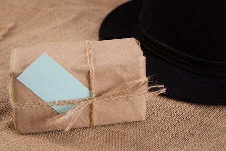 Gift box on the table.Nearby hat.Fathers Day congratulation conceptの写真素材