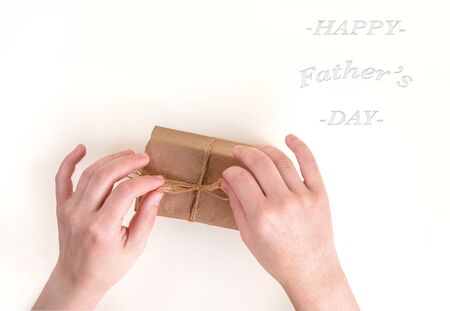 Hands pack a gift box. Space for text.の写真素材