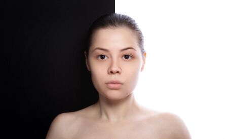 Beautiful young woman with clean fresh skin on her face. black and whiteの写真素材