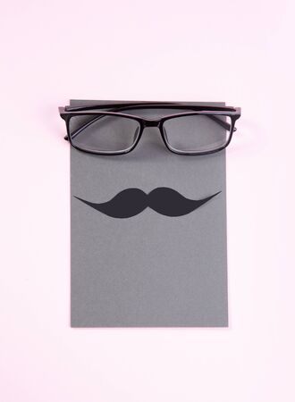 glasses and mustache on a delicate pink background. gift card for fathers day.の写真素材