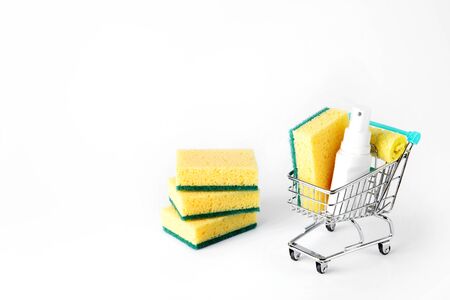 shopping cart with detergents and sponges for dishes. free space for textの写真素材