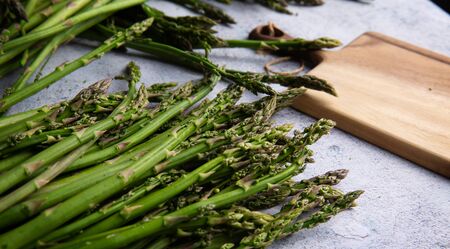 Bunches Fresh green asparagus on the board. top view - imageの写真素材