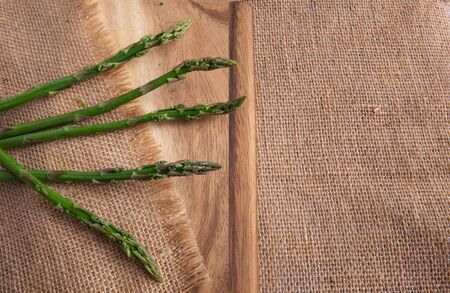 Bunches Fresh green asparagus on the board. top view - imageの写真素材