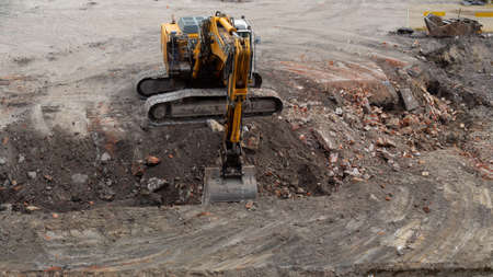 yellow construction excavator during work. view from above. High quality photo