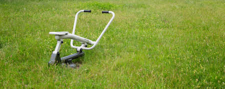 outdoor exercise machine stands on grassy ground. High quality photoの写真素材