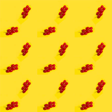 red currant on a yellow background. seamless texture. pattern.