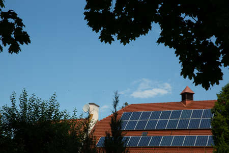 solar panels on the red roof of the houseの写真素材
