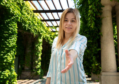 The blonde smiling extended her hand forward. selective focusの写真素材