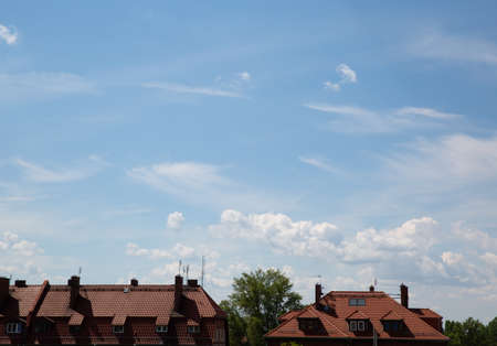 red roofs of houses against the skyの写真素材