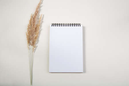 White notepad mockup on light table . top view . free space for text.