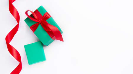 Christmas green gifts with red ribbon on  white