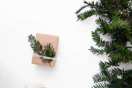Easy brown paper gift with Christmas tree on white tableの写真素材