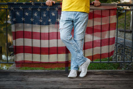 legs in ripped jeans and fabric with American flag printの写真素材