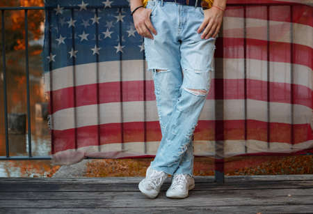 legs in ripped jeans and fabric with American flag printの写真素材