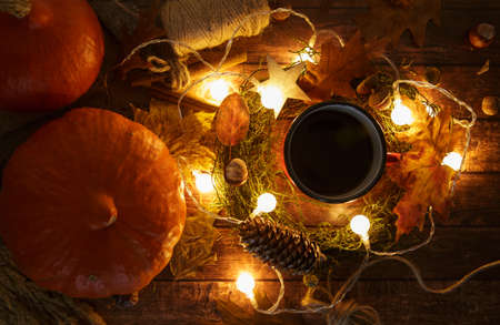 mug with coffee garland and pumpkin on a wooden tableの写真素材