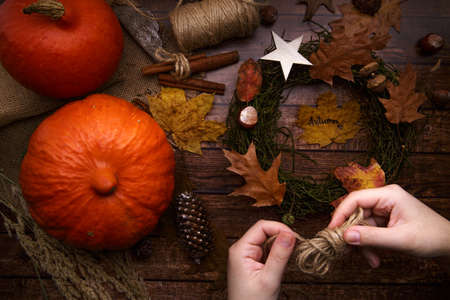 The child is engaged in creativity makes an autumn wreathの写真素材