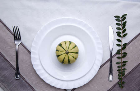 Thanksgiving or Halloween place setting with mini pumpkinの写真素材
