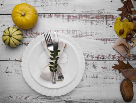 autumn composition with pumpkins and cutlery on an old tableの写真素材