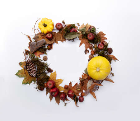 Autumn wreath made from yellow pumpkins and leavesの写真素材