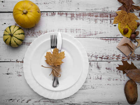 composition with pumpkins and cutlery on an old tableの写真素材