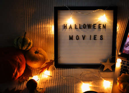 Frame with letters on sofa with pumpkins and garlandの写真素材
