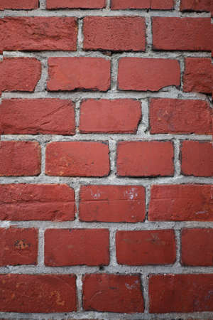 texture of a brick wall made of red bricks bonded with cement mortarの写真素材