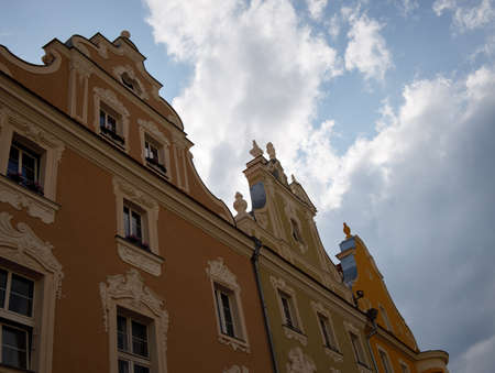 part of the facade of house in German style painted in beige against light sky