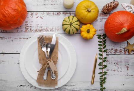 autumn composition with cutlery plate and pumpkins .の写真素材