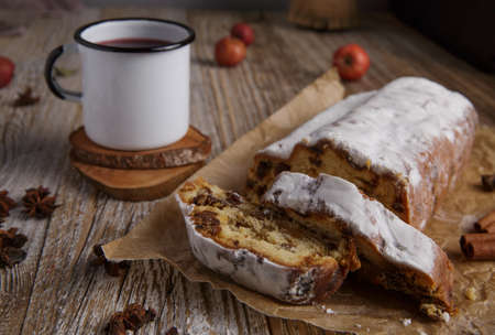 traditional Christmas stollen and tea mug on wooden table.selective focusの写真素材