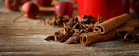 anise stars and cinnamon sticks with apples on a wooden table. selective focus . High quality photoの写真素材