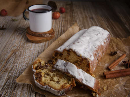 traditional Christmas stollen and tea mug on wooden table.selective focus .の写真素材