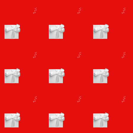 white gift boxes on red background. Seamless pattern, holiday concept . High quality photoの写真素材
