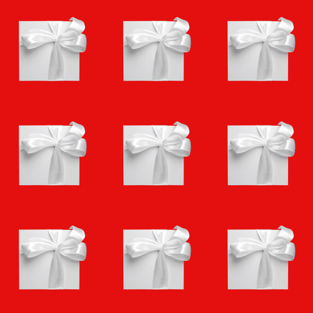 white gift boxes on red background. Seamless pattern, holiday concept.の写真素材