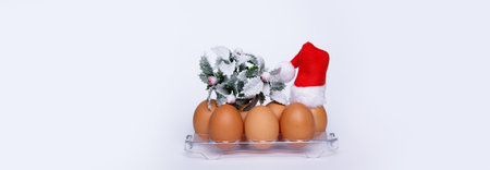 chicken eggs on a tray from the refrigerator and Santa hat . selective focus