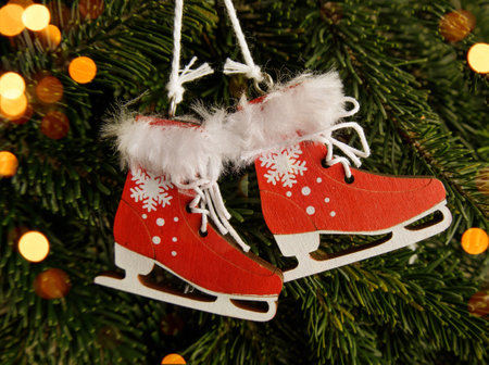 New Years and New Years toys hang on the tree. red wooden skates with fur on a branch. Christmas and New Years concept. garland lightsの写真素材