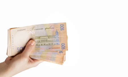 the girl hand holds bills of large denomination of the Ukrainian bank on the white background . High quality photoの写真素材