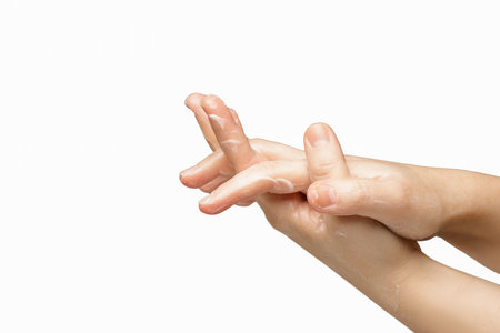 Female hands isolated on white applying massage cream. Health and beauty concept. hand in hand.isolate.の写真素材