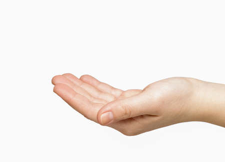 Female caucasian hand slightly bent the palm on a white background isolate. health and beauty conceptの写真素材