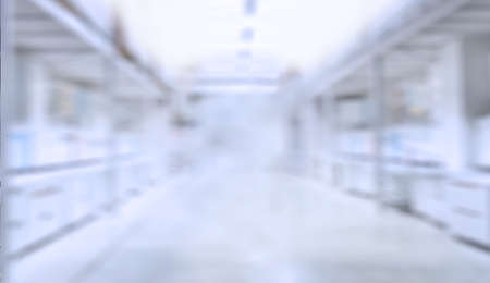blurry image of a store or empty space. white and blue background. defocus.の写真素材