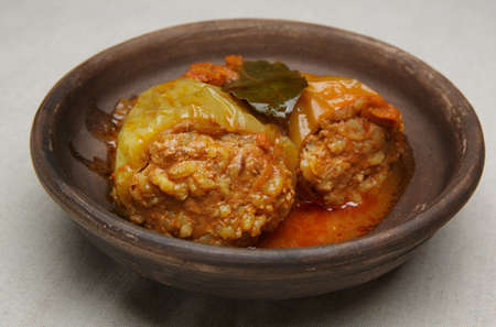 bell pepper stuffed with meat and rice in red tomato sauce on a plate. close-up. selective soft focus. healthy foodの写真素材
