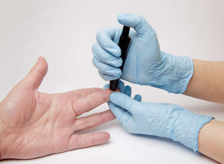 taking a blood test for the amount of sugar level. selective focus. High quality photoの写真素材