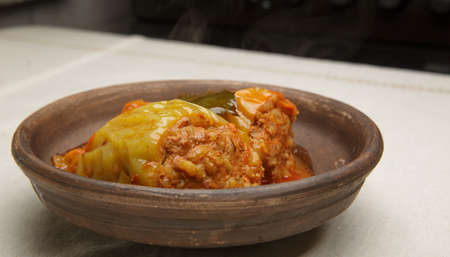 bell pepper stuffed with meat and rice in red tomato sauce on a plate. close-up. selective soft focus. healthy foodの写真素材
