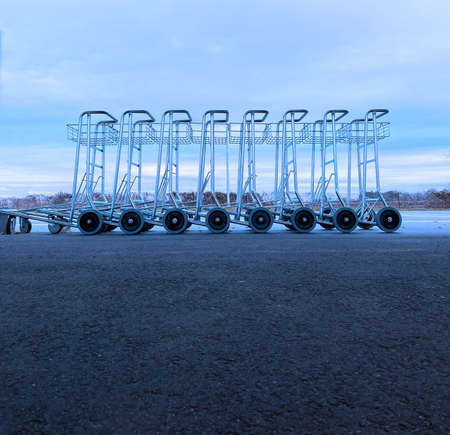empty luggage trolleys at bus station against cold winter sky. selective focus.High quality photoの写真素材